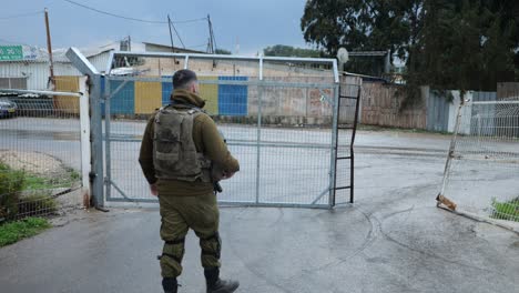 Israeli-Army-Soldier-in-Uniform-and-Body-Armor-Opens-Gates-in-Rural-Area---Slow-motion
