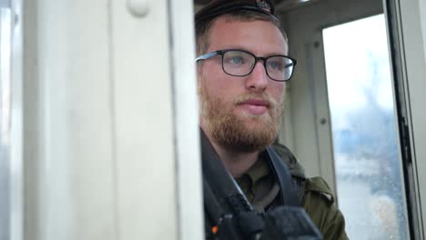 -IDF-Israel-Soldier-in-Military-Uniform-With-Rifle-on-Duty-in-Sentry-Box-on-Rainy-Day---dolly-in