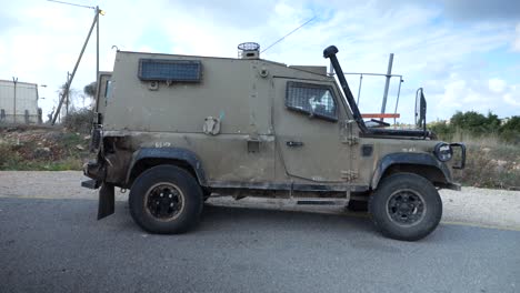 Young-IDF-Armed-Soldiers-in-Uniform-With-Machine-Guns-Running-and-Get-Inside-Humvee-Military-Car-and-Depart-on-Mission