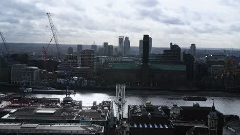 Looking-down-towards-people-crossing-the-Millennium-Bridge-from-up-at-St-Paul's-Cathedral,-London,-United-Kingdom