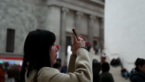 Close-up-of-someone-taking-images-within-the-British-Museum,-London,-United-Kingdom