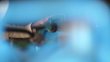 Bokeh-View-Through-Blue-Pipe-Of-Person-Checking-Pipe-Tank