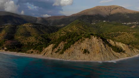 Rocky-coastline-of-Albania-with-hills-and-mountains-surrounded-by-blue-azure-sea-water