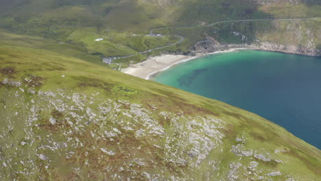 Aerial-reveal-shot-of-Keem-Bay-on-Achill-Island,-Ireland
