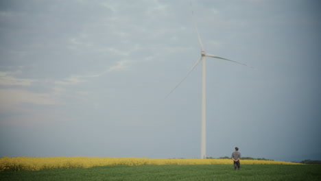 Farmer-Walking-Amidst-Plants-In-Farm