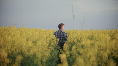 Farmer-Walking-Amidst-Flowering-Plants-In-Farm