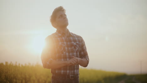 Thoughtful-Male-Farmer-In-Farm-At-Sunset