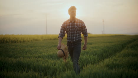 Farmer-Walking-Amidst-Grass-In-Farm