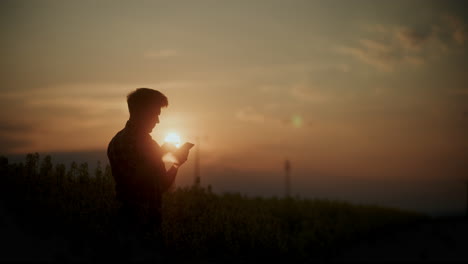 Agronomist-Using-Tablet-PC-In-Farm-At-Sunset