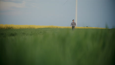 Farmer-Walking-In-Farm-Against-Sky