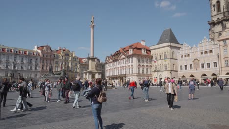 people-walking-and-exploring-the-historic-Old-Town-Square-in-Prague,-Czech-Republic