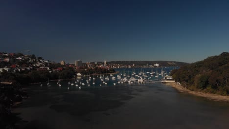 Aerial-lift-off-views-capture-Balgowlah-Bay-with-Boats,-yachts,-beaches-and-buildings
