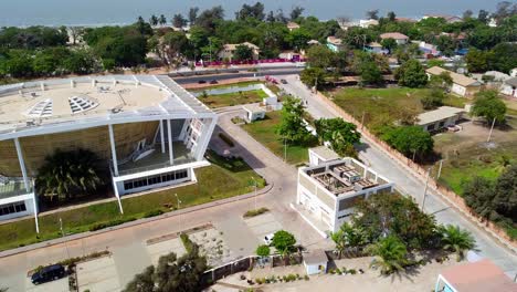 Establishing-shot-of-Gambia-National-Assembly-building-and-arch-in-banjul,-drone