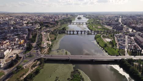 Old-and-new-bridges-over-the-river-Guadiana-in-Badajoz,-Spain,-aerial-dolly-out