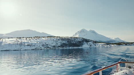 Cinematic-Wide-Static-Shot-of-Boat-Cruise-Sailing-along-the-Arctic-Fjords-in-Norway