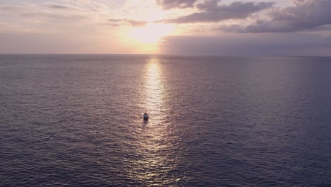 Wide-shot-of-fishing-boat-on-calm-ocean-near-Mallorca,-aerial