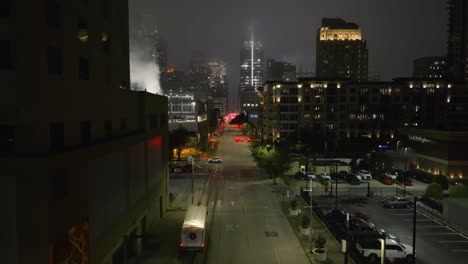 Drone-shot-through-the-foggy-streets-of-downtown-Houston,-night-in-Texas,-USA