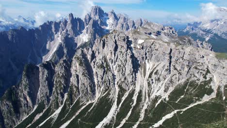 Breathtaking-aerial-of-Cadini-di-Misurina-mountain-peaks,-tilt-down-to-Auronzo-Valley