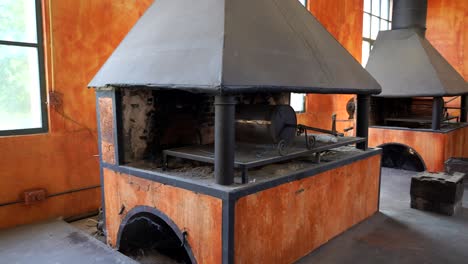 Pan-right-shot-of-coal-bunkers-in-old-forge,-Guadalajara,-Spain