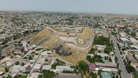 Flying-Towards-Old-Castle-In-Istaravshan,-Tajikistan---drone-shot