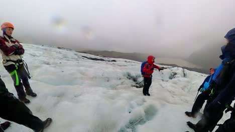 Iceland---Glacier-Wonderland:-A-hiker-walks-through-a-wonderland-of-ice-formations-on-Falljökull-glacier,-the-blue-ice-sparkling-in-the-sunlight,-in-this-stunning-video