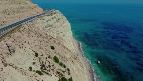 Magical-cliff-side-road-in-tropical-island,-aerial-drone-view
