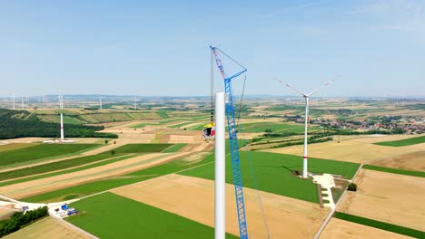 Construction-Site-Of-Wind-Turbine-In-Summer-Fields---aerial-drone-shot
