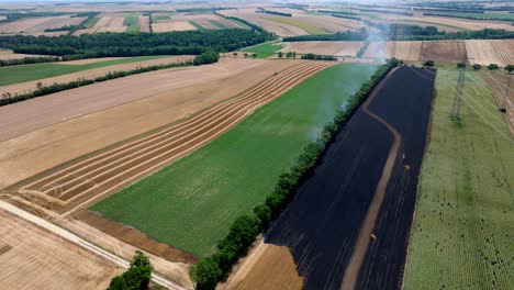 Panoramic-View-Over-Burnt-Agricultural-Fields---drone-shot