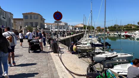 Pov-walk-along-port-of-Saint-Martin-de-Ré-in-France-and-many-tourist-in-summer