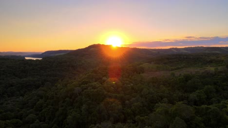 Drone-flying-over-the-rainforest-of-Misiones,-Argentina-towards-the-setting-sun