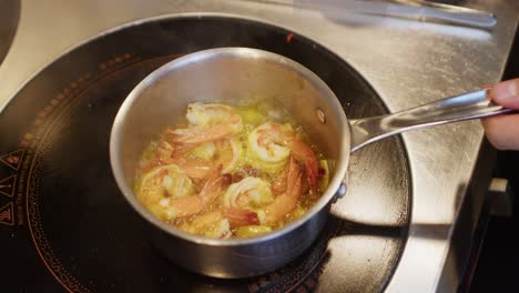 Chef-preparing-Mediterranean-shrimp-seafood-soup-in-a-pot,-professional-kitchen-restaurant-footage