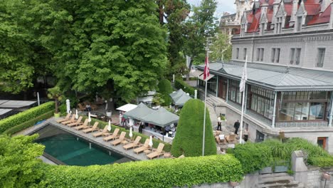 Aerial-overview-of-busy-outdoor-cafe-of-historical-hotel-in-Lausanne,-Switzerland