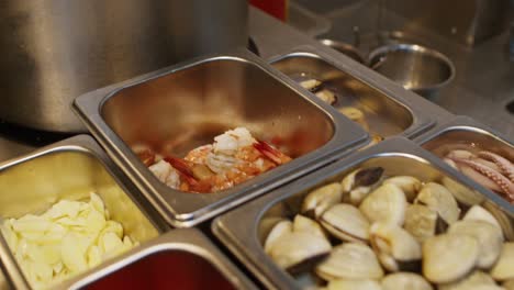 Seafood-ingredients-for-Mediterranean-pasta-soup-preparation-in-a-professional-restaurant-kitchen