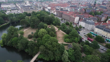 An-aerial-glimpse-of-Ørstedsparken-showcases-its-green-trees-and-glistening-lakes,-forming-a-picturesque-escape-within-the-heart-of-Copenhagen's-urban-sprawl