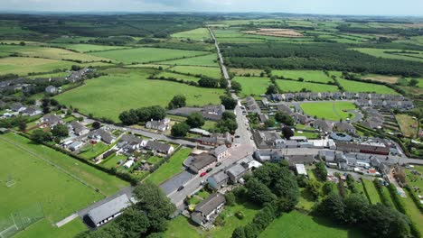 Drone-flying-to-Kill-Village-Waterford-Ireland-popular-tourist-village-near-The-Copper-Coast-Drive-on-a-warm-summer-day
