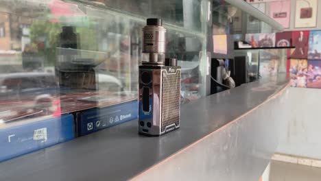 Vape-smoking-bottle-on-counter-with-reflection-glass