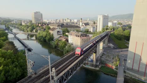 Aerial-footage-of-a-train-in-Zurich,-the-capital-and-the-largest-city-in-Switzerland