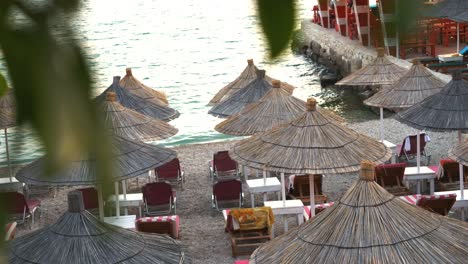 Straw-umbrellas-and-beach-chairs-on-the-seaside-in-Saranda