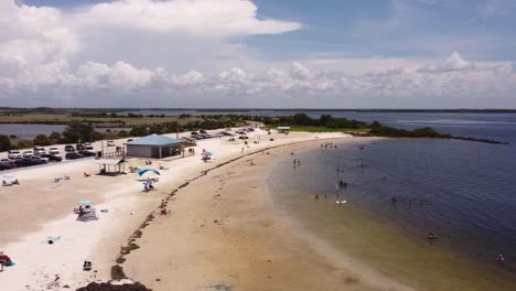 Aufnahme-Einer-Drohne,-Die-Nach-Links-über-Einen-Kleinen-Strand-Auf-Einer-Halbinsel-In-Florida-Schwenkt