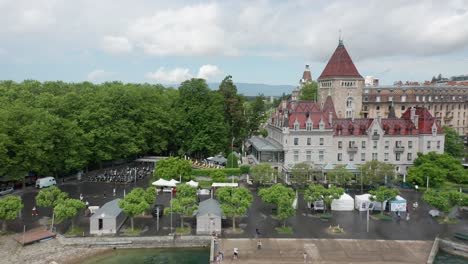 Aerial-of-Chateau-d'Ouchy,-a-beautiful-hotel-and-restaurant-in-downtown-Lausanne,-Switzerland