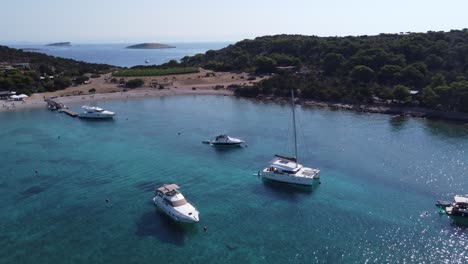Boats-and-Yachts-of-Various-types-anchored-in-Turquoise-clear-water-of-Blue-Lagoon-Bay-at-Veliki-Budikovac-Island,-Croatia