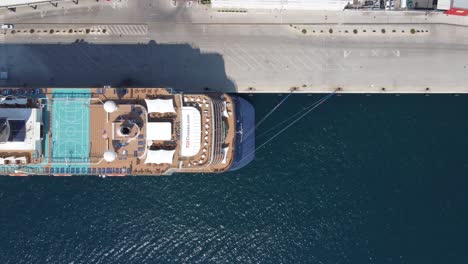 Panoramic-bird's-eye-Aerial-of-premium-luxury-Cruise-Ship-Mein-Schiff-and-its-sun-deck-recreational-area-docked-at-port-Gruz-in-Dubrovnik-with-Shuttle-buses-to-transport-tourists-to-city-center
