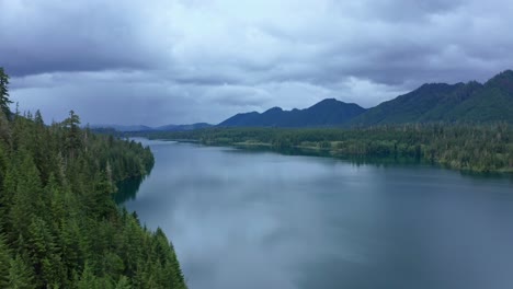 Aerial-over-scenic-lake-surrounded-by-forested-mountains-in-Pacific-Northwest