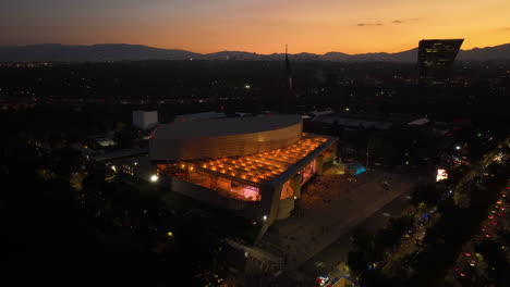 Drone-shot-approaching-the-illuminated-National-Auditorium,-nighttime-in-CDMX