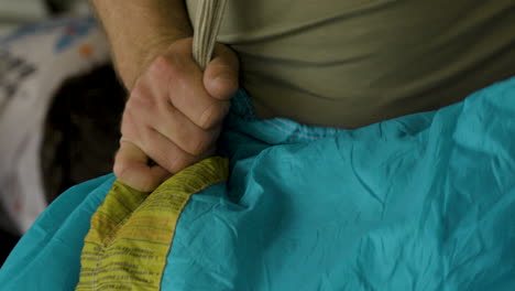 Close-Up-Hand-Holding-Ripcord-Of-Parachute