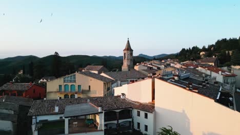 Aerial-Drone-Above-Viladrau-Little-Village-in-European-Countryside-Comarca-of-Osona,-Catalonia,-Old-Traditional-Architecture,-Hills-and-Skyline