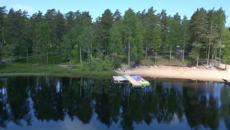 Drone-shot-Isaberg-Mountain-Resort-in-Sweden-with-green-forest-and-lake