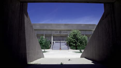 Hilton-Coliseum-on-the-campus-of-Iowa-State-University-in-Ames,-Iowa-with-view-through-crosswalk-and-stable-video