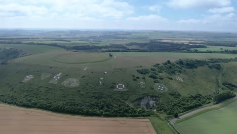 Establishing-aerial-view-towards-the-set-of-regimental-badges-carved-into-Fovant-chalk-hillside-in-the-Wiltshire-countryside
