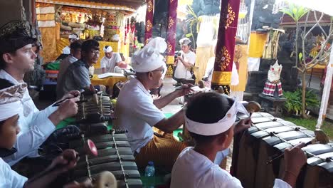 Young-Musicians-Play-Gamelan-Music-at-Hindu-Temple-Ceremony-in-Bali,-Indonesia,-Colorful-Religious-Meeting-with-Cultural-Traditional-Art